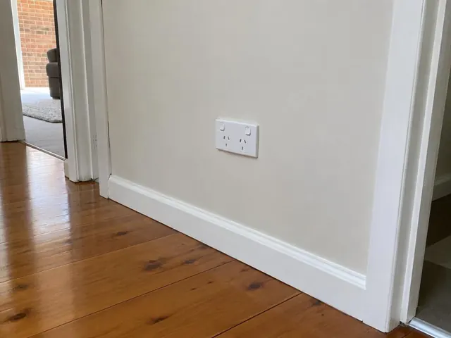 White double power point on a painted hallway wall above timber floorboards in Beresfield